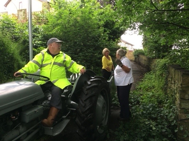 TQ10 Man on tractor talking to two volunteers