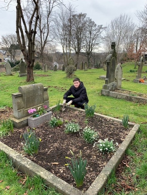 BEG-mar1 One of our Duke of Edinburgh volunteers showing the snowdrops he’s just planted on one of the adopted graves in All Hallow’s church yard.