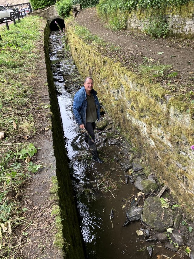 Volunteer clearing the stream.