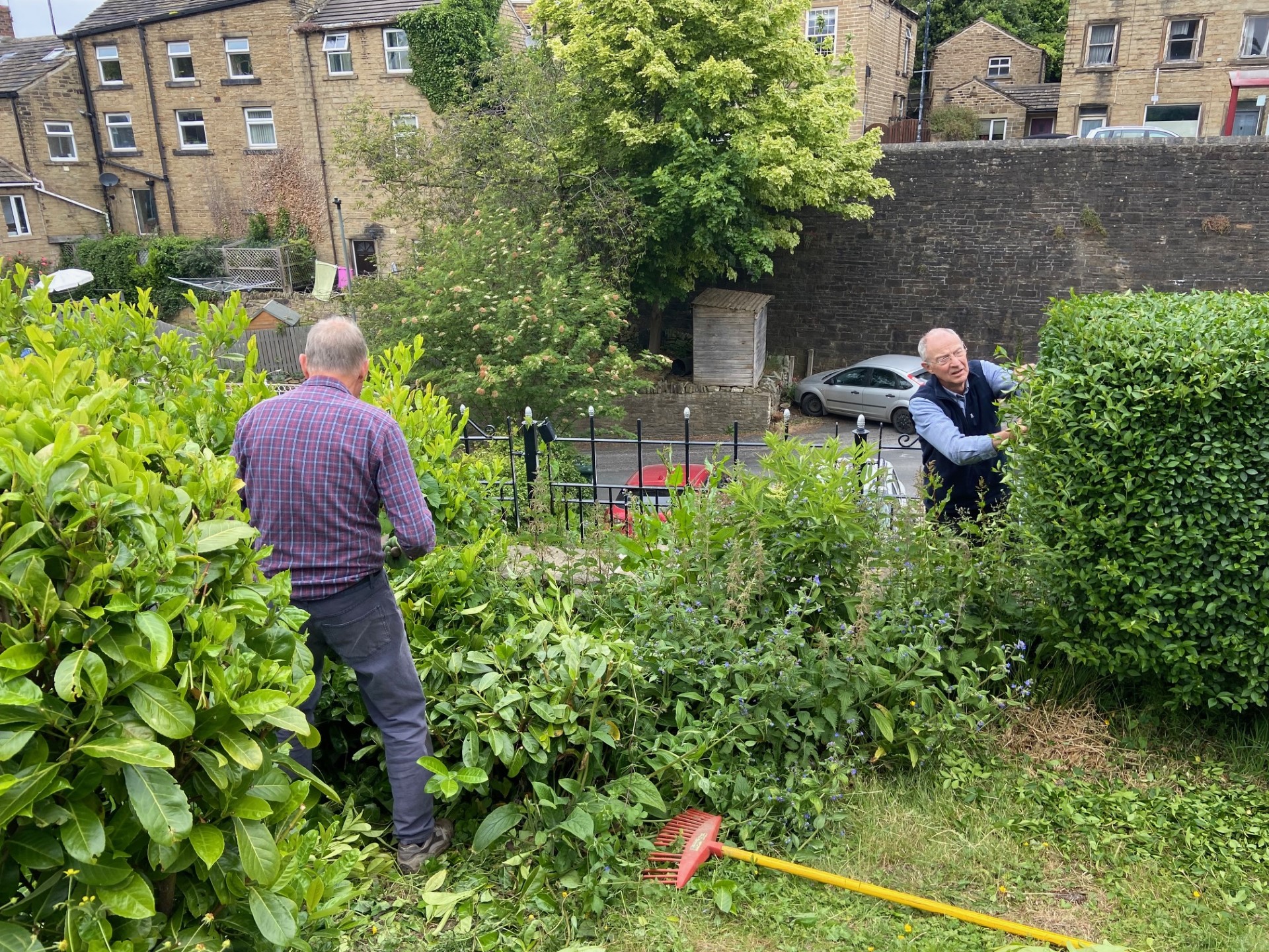 The Memorial Gardens being tidied up by volunteers - trimming all the shrubs, cutting grass and deadheading plants.