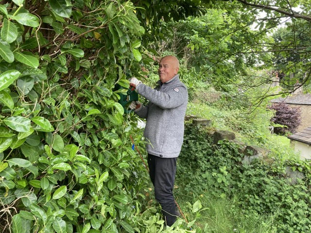 The Memorial Gardens being tidied up by volunteers - trimming all the shrubs, cutting grass and deadheading plants.