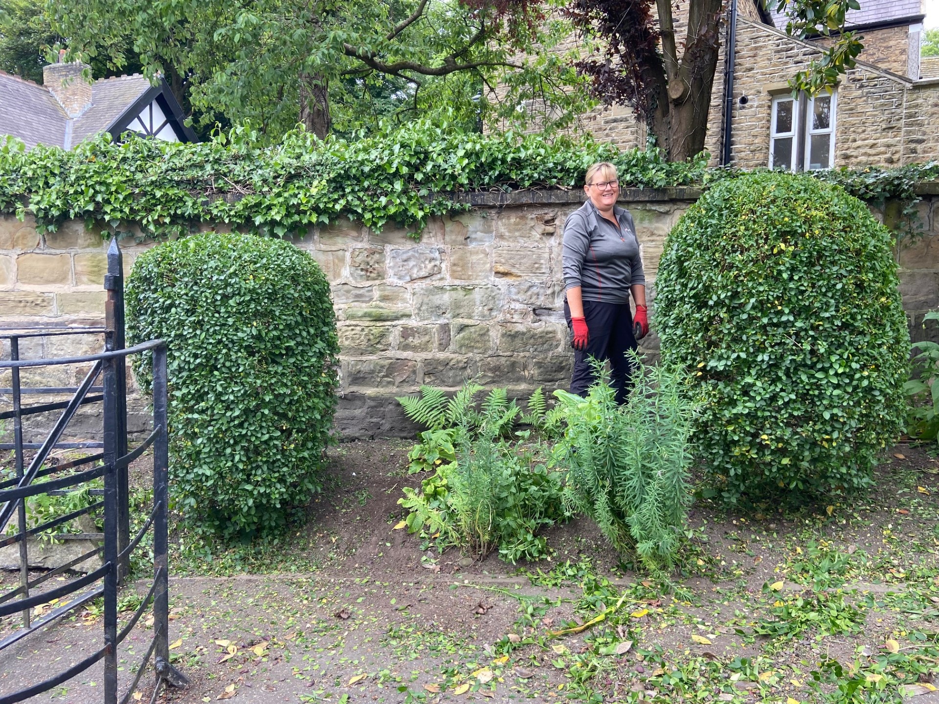 The Memorial Gardens being tidied up by volunteers - trimming all the shrubs, cutting grass and deadheading plants.
