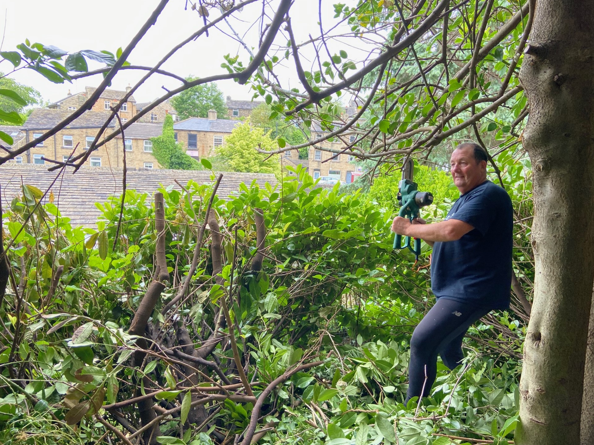 The Memorial Gardens being tidied up by volunteers - trimming all the shrubs, cutting grass and deadheading plants.