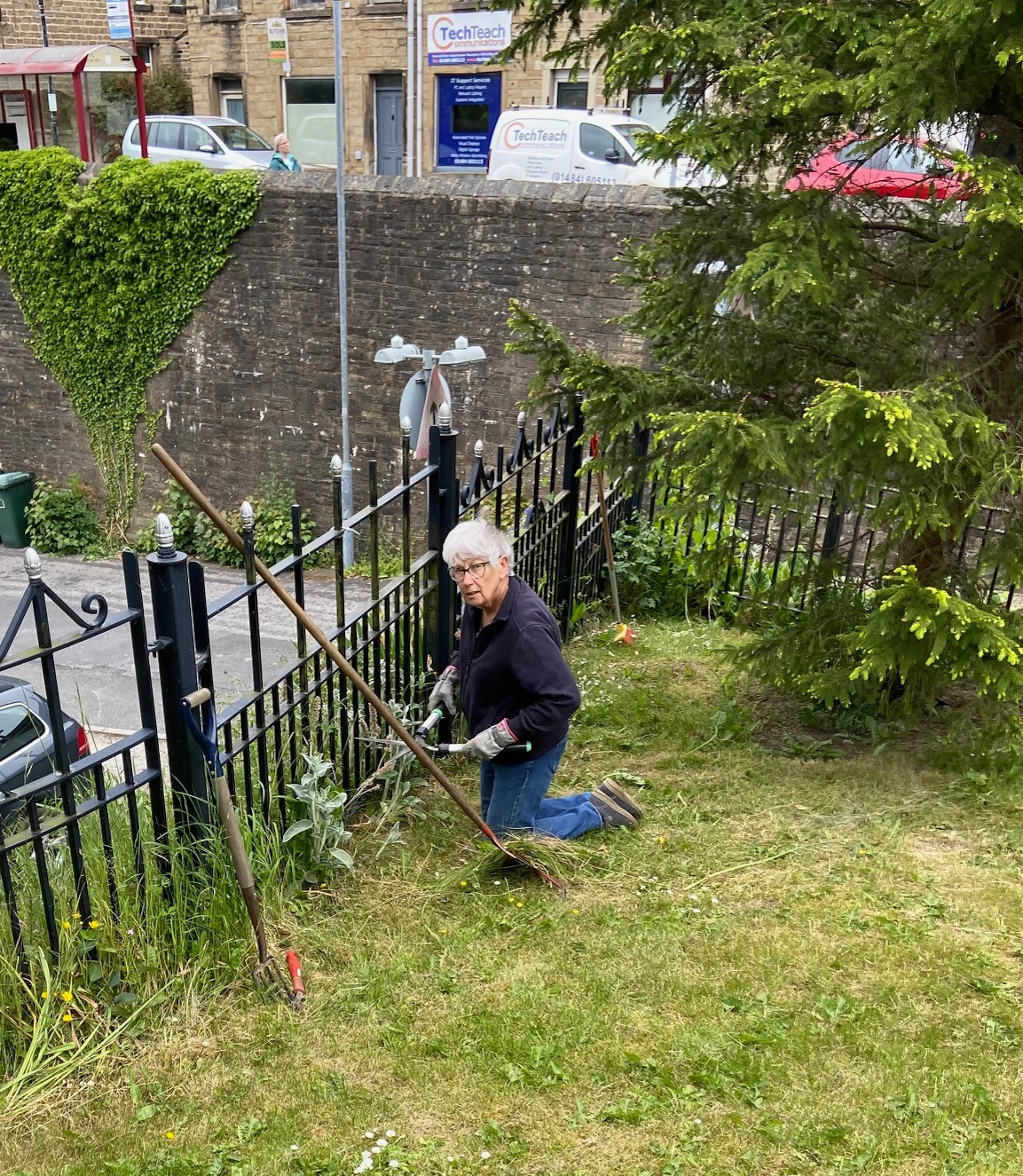 The Memorial Gardens being tidied up by volunteers - trimming all the shrubs, cutting grass and deadheading plants.