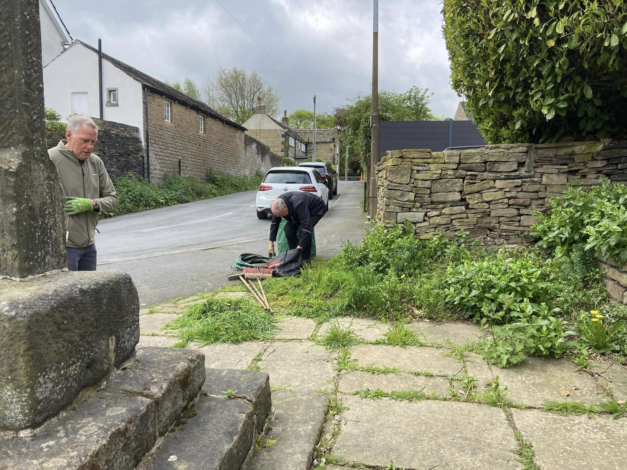 Volunteers clearing stone slabs in the High Burton Cross area