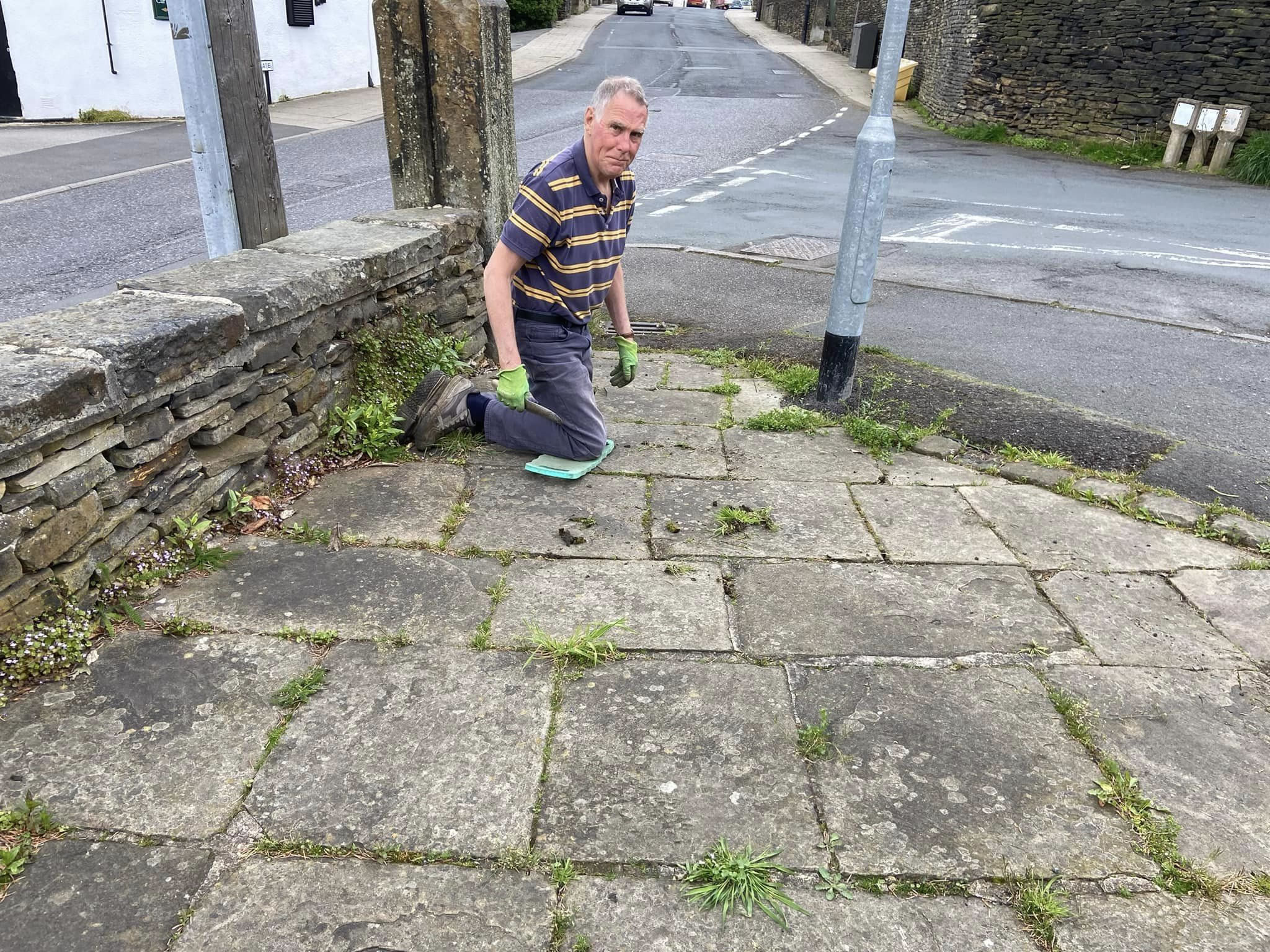 Volunteers clearing stone slabs in the High Burton Cross area