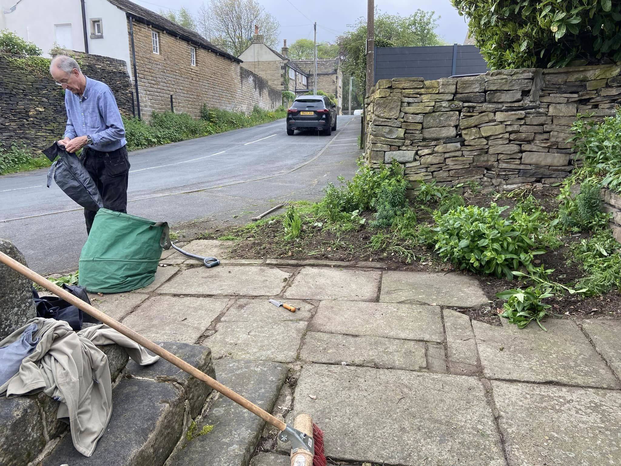 Volunteers clearing stone slabs in the High Burton Cross area