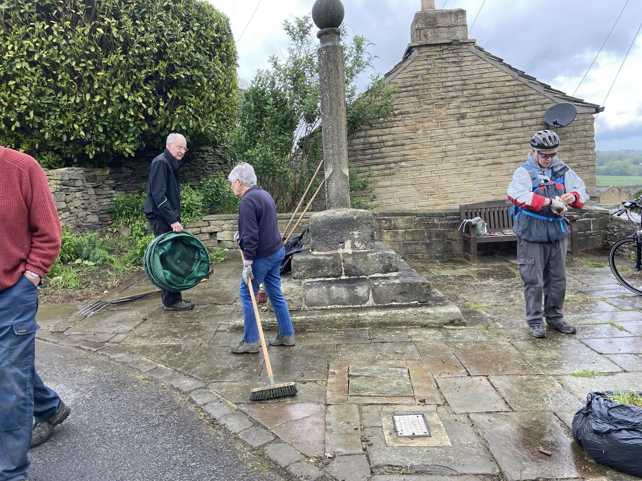 Volunteers clearing stone slabs in the High Burton Cross area