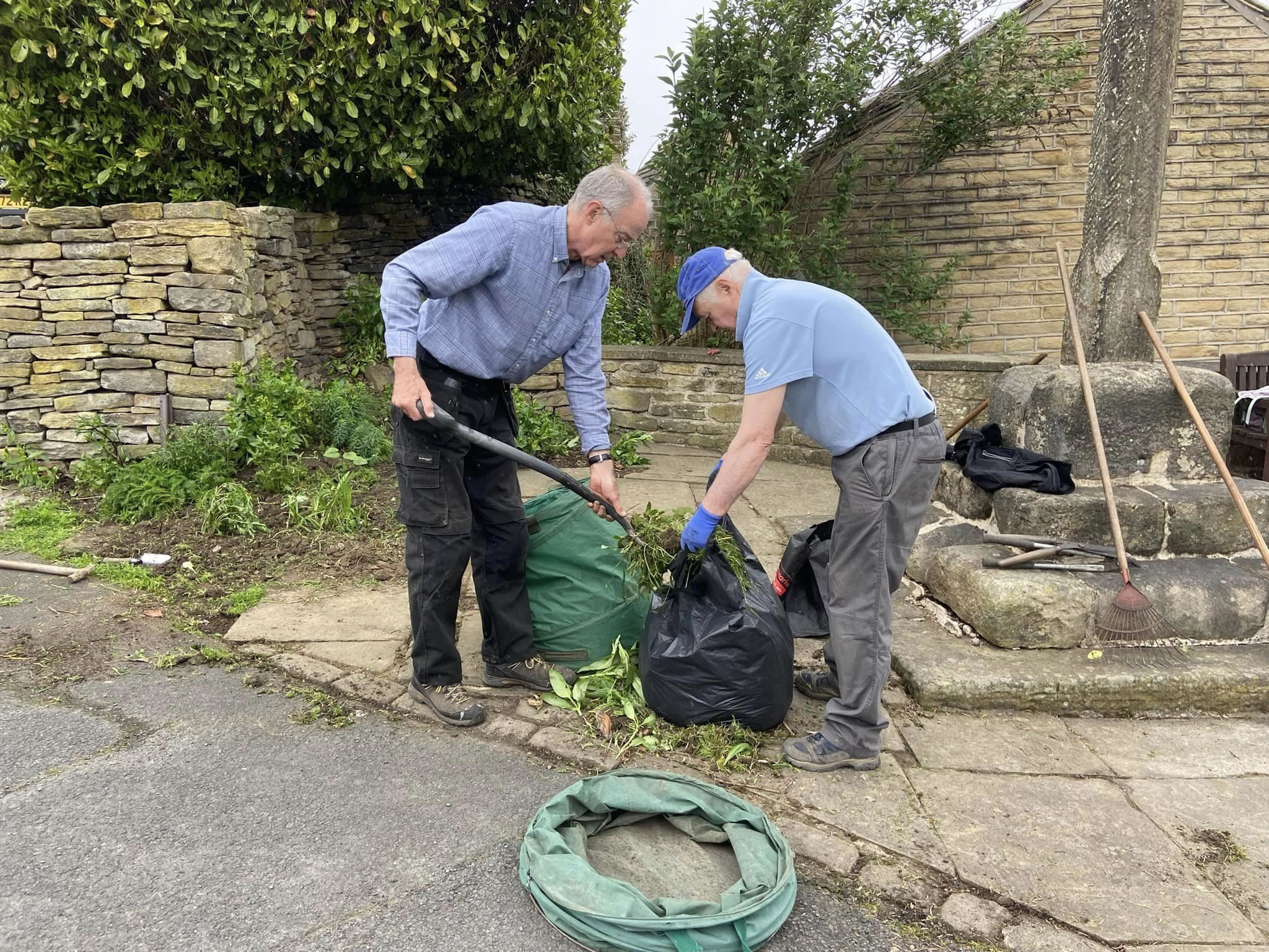 Volunteers clearning overhanging branches and thistles