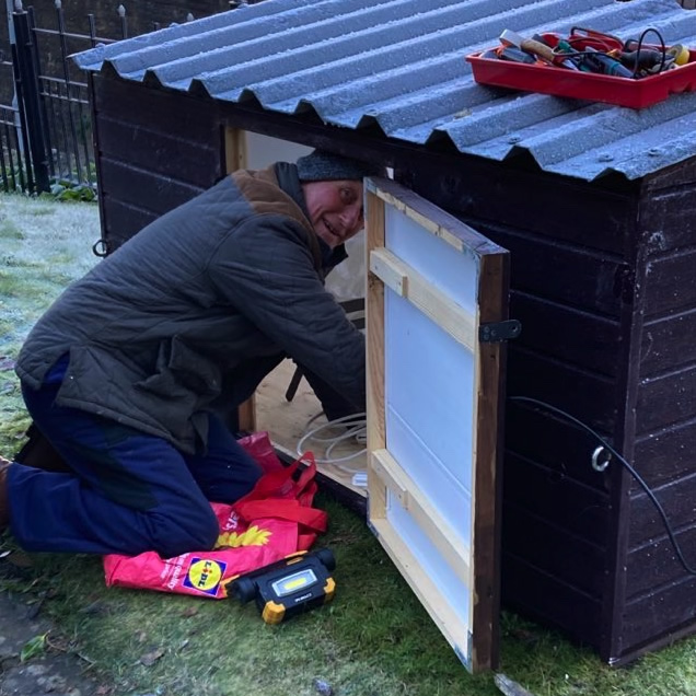 Volunteer preparing the crib display