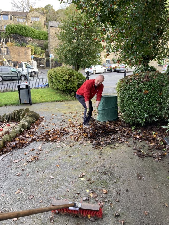 Clearing leaves in the Memorial Gardens for the Service of Remembrance
