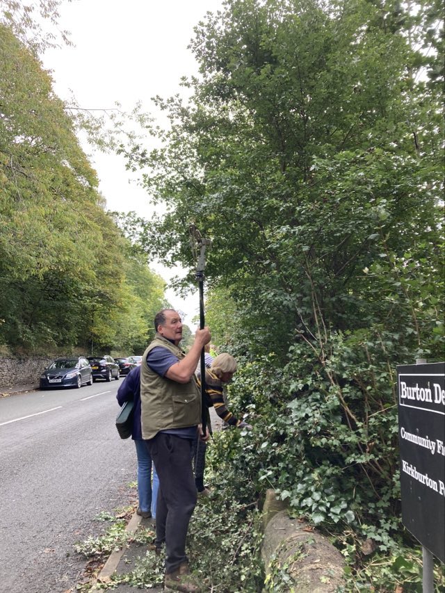 Volunteers clearing foliage to keep paths clear for pedestrians
