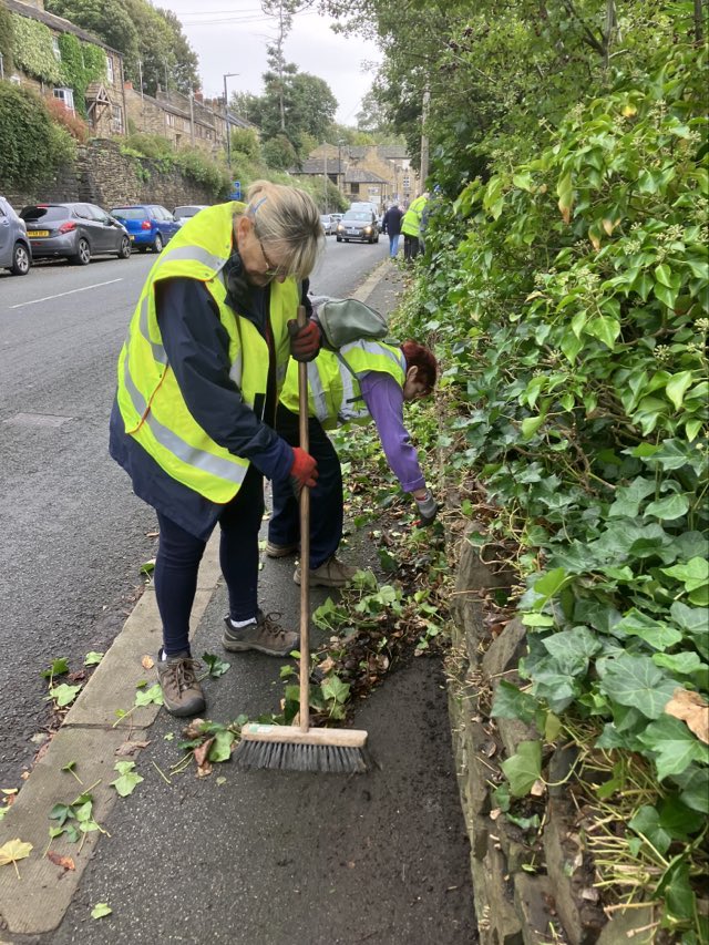 Volunteers clearing foliage to keep paths clear for pedestrians